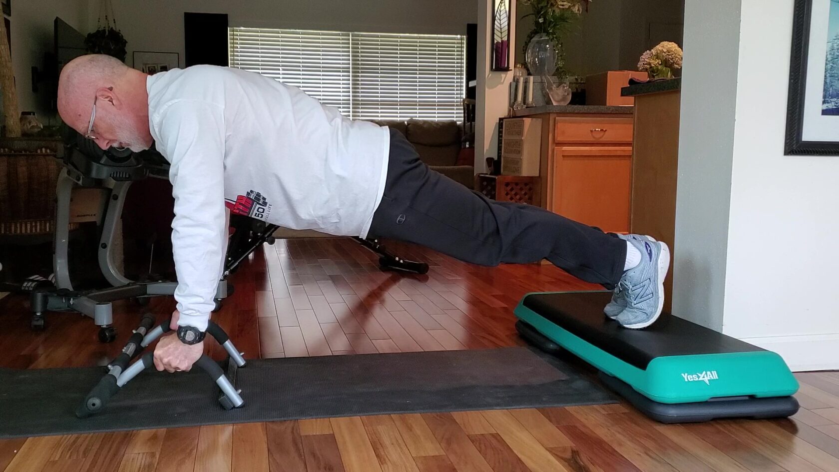 fitness gifts pushup bars and fitness step with risers being used for pushups