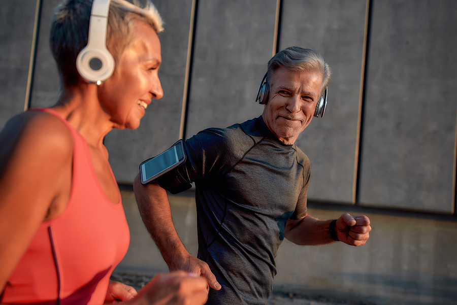 Older couple running together - strength training for runners over 50